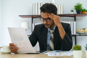 A person analyzes a document.