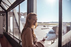 A woman waits for her flight.