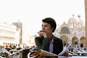 Businesswoman working in outdoor cafe in Italy