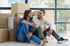 Shot of a happy young couple moving into their new home together