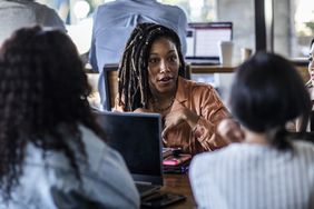 A woman talks during a business meeting.