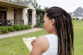 A real estate agent looks at a home.