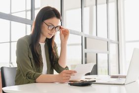 A person looks at a piece of paper.