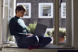 A business proprietor looks up tax information on a laptop