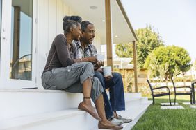 Mature couple drinking coffee on porch