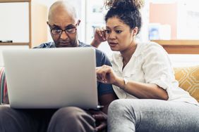 Two people looking at a computer