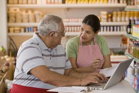 Hispanic business owners using laptop