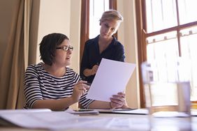 Two women reviewing tax paperwork