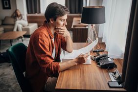 A man looks at a piece of paper.