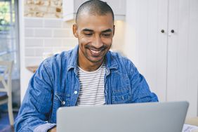 Man using a laptop while working at home