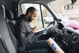 Delivery driver using tablet in truck