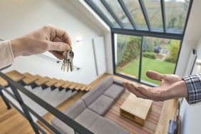 Realtor giving house keys to buyer