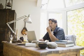 A man working at a laptop at home