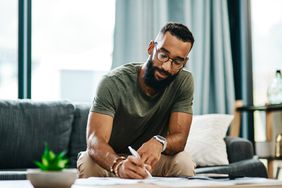 Man writing a check for an extra mortgage payment