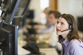 USA, New York, New York City, Female trader at trading desk