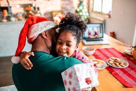 孩子拿着礼物拥抱她的父亲是谁戴着圣诞老人的帽子”>
          </noscript>
         </div>
        </div>
       </div>
       <div class=