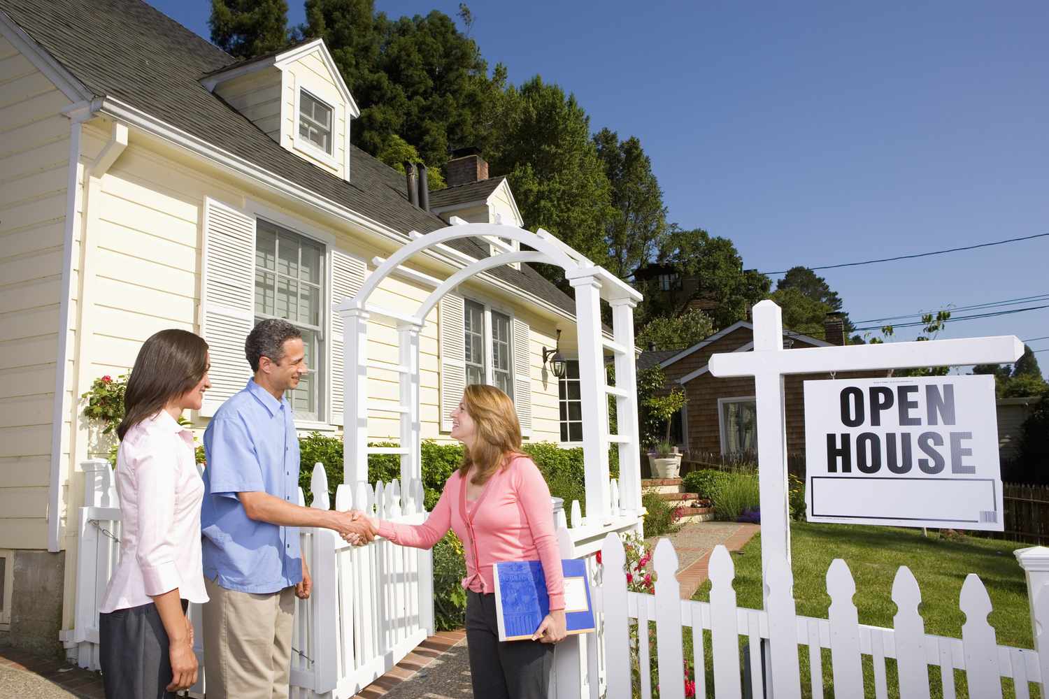 购房者与房地产经纪人握手以外的房屋出售”class=