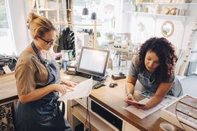 Women small business owners figuring out finances, budget, scheduling