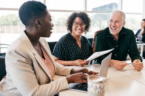 Business partners discuss a loan agreement with a lender