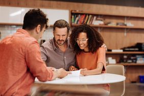 A couple signs a loan agreement.