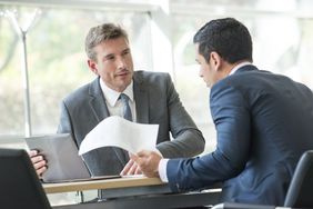 Businessmen negotiating in meeting