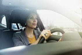 Women sitting in car driving to work
