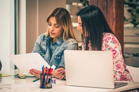 Women in an office reviewing financial documents