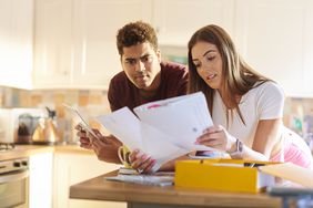 A couple looks over paperwork.